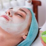 Woman lying down receiving a facial treatment