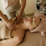 Woman lying down receiving Gua Sha treatment in a SPA