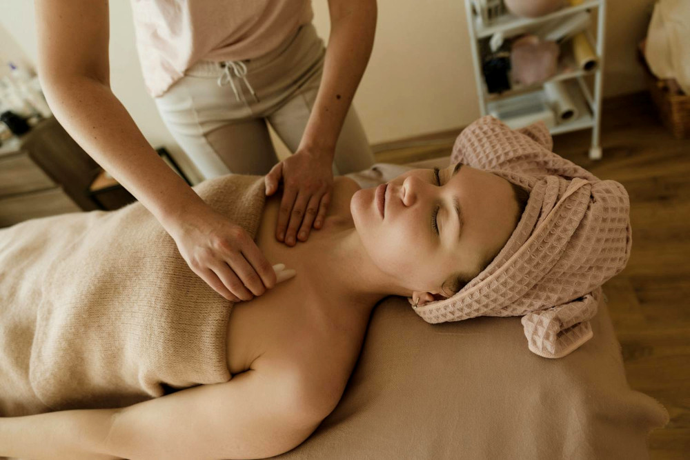 Woman lying down receiving Gua Sha treatment in a SPA