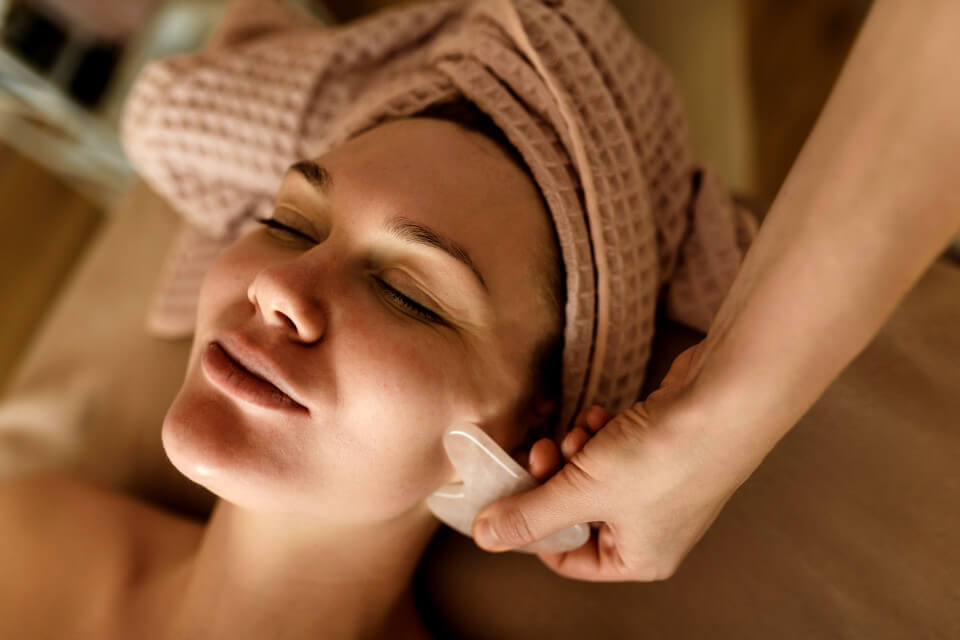 Lady receiving Gua Sha Treatment