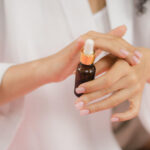 Woman putting Retinol on her hand.